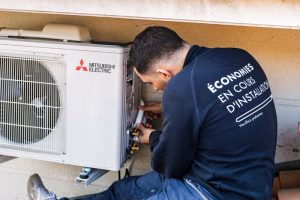 Technicien ClimeHome en train de monter un groupe extérieur Mitsubishi blanc